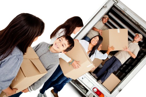 Moving truck and packed boxes for a home move in Maida Vale
